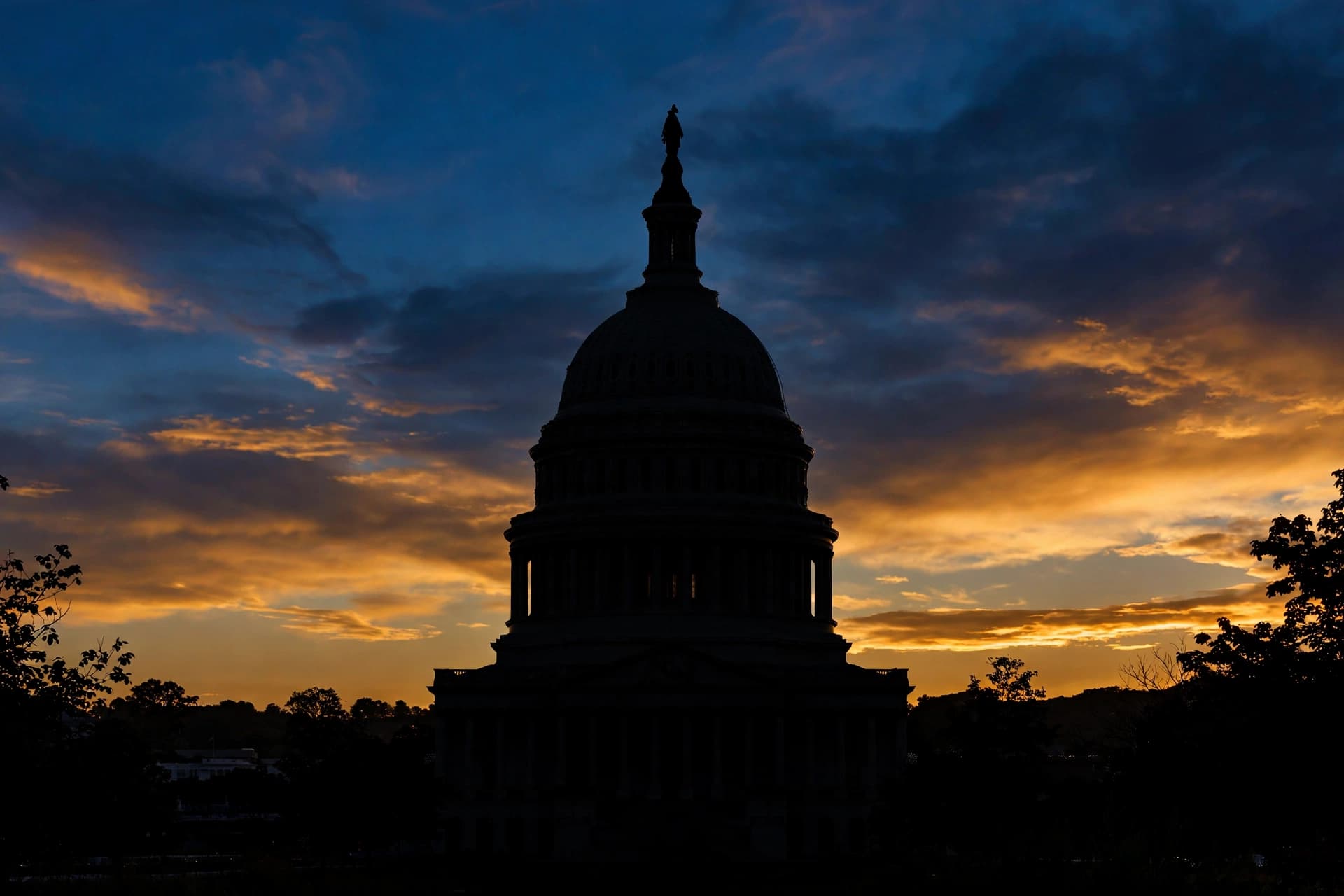 US Capitol dome silhouette at dusk, symbolizing federal legislation on dating app fraud